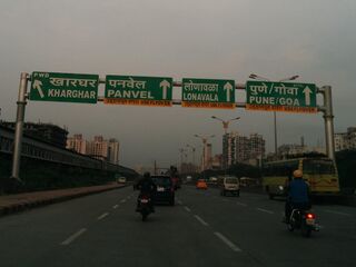 A road sign on Sion Panvel Highway in India instructing travellers to use flyover for onward journey.