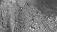 Some of the layers of Danielson Crater is just visible in this CTX image. Dunes are also visible.