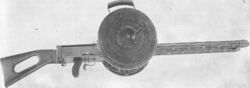 Gast machine gun with drum magazines.jpg
