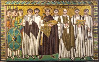 A crowned man holding a bowl, surrounded by clerics, courtiers and guardsmen