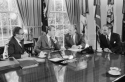 President Richard Nixon seated at his Oval Office desk during a meeting with Henry Kissinger, Alexander Haig, and Gerald Ford.jpg