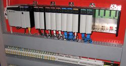 Modular PLC with EtherNet/IP module, digital and analog I/O, with some slots being empty.