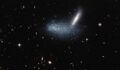 Irregular dwarf galaxy PGC 16389 covers its neighboring galaxy APMBGC 252+125-117.[27]