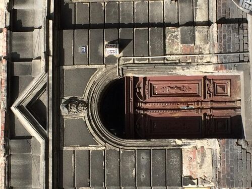 The gate and the overlooking figure