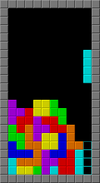 In a black, upright rectangle bordered by gray squares, multiple tetrominoes of different colors are stacked on top one another, leaving a gap to the right that an I-shaped tetromino is about to enter vertically.