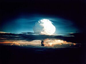 A mushroom cloud lights up the dawn sky