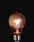 An incandescent light bulb with its glowing filament.