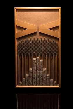 Beans in a Galton box forming the shape of the Gaussian density curve.