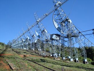 The 530-metre (1,740 ft) long and 30-metre (98 ft) tall cylindrical parabolic antenna at Ooty Radio Telescope Complex near Ooty, Tamil Nadu, India (Early 1970s)