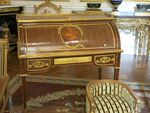 Louis XVI style roll-top desk of Marie-Antoinette; by Jean-Henri Riesener; 1784; oak and pine frame, sycamore, amaranth and rosewood veneer, bronze gilt; 103.6 x 113.4 cm; Louvre[59]