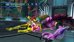 A person in a powered armor grabs a chameleon-like creature. Atop the screen are 2D icons which indicates the health and ammo of the player.
