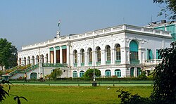 Large white rectangular building with tall arched windows