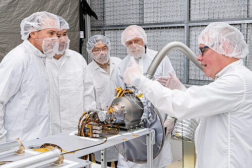 U.S. and Japanese team members with the gamma-ray spectrometer portion of the MEGANE instrument at Johns Hopkins APL.