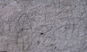 Prehistoric glyphs carved on a rock wall