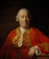 Oil painting showing a man from the front against a dark background, dressed in a red coat with gold embroidery, his left arm resting on a surface