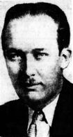 Black-and-white portrait of an adult man with slicked-back hair and a toothbrush mustache.