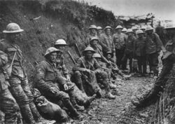 Mud stained British soldiers at rest