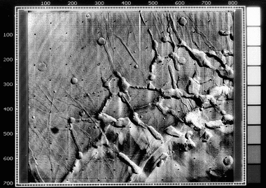 Mariner 9 view of the Noctis Labyrinthus "labyrinth" at the western end of Valles Marineris on Mars. Linear graben, grooves, and crater chains dominate this region, along with a number of flat-topped mesas. The image is roughly 400 km across, centered at 6 S, 105 W, at the edge of the Tharsis bulge. North is