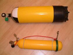 Two steel cylinders are shown: The larger is about twice the diameter of the smaller, and about 20% longer.