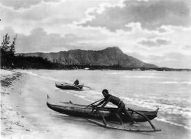 Polynesians with outrigger canoes at Waikiki Beach, Oahu Island, early 20th century