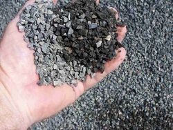 Photo of an outstretched hand containing gravel