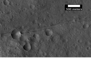 Close-up of a possible fault in Mare Acidalium, as seen by HiRISE under the HiWish program. A circle is drawn around crater to show that it may be off round because of movement of the fault. Many other faults are in the region.