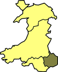 A map of Wales in yellow with a small area in green (about 5%) at the bottom right (south east)