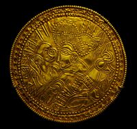 A C-type bracteate (DR BR42) featuring a figure above a horse flanked by a bird