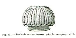 Black and white sketch of a sculptural element. The object is oval in shape and features longitudinal carvings.