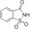 Saccharin, a cyclic sulfonamide that was one of the first artificial sweeteners discovered