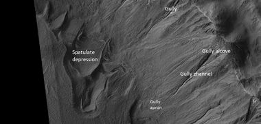 Close view of crater labeled with "spatulate depression" and other features, as seen by HiRISE. Note: this is an enlargement of the previous image.[37]