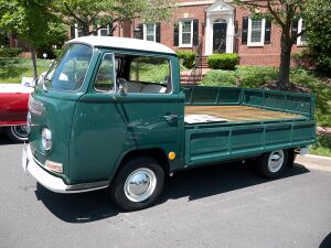 Volkswagen Type 2 with single cab over and a drop side bed with the left panel folded down