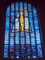 The principal window of the Temple of Maipú, Chile, depicting the Virgin Mary and Christ Child, by Adolfo Winternitz, showing the traditional use of blue as the predominant colour, emphasising an association with Heaven.
