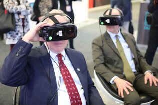 Two men using cell phones placed inside VR headsets in 2018. The same year Steven Spielberg's Ready Player One released, which featured Vive Virtual Reality headsets and helped advance motion capture.
