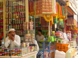 four men in traditional bridalwear shops in the market