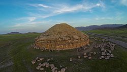 Round pyramid in a middle of a grassy plain
