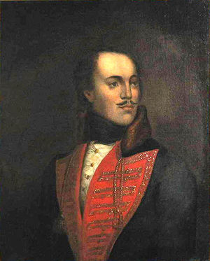 Picture of a painting of a man with a mustache wearing a red V collar; the man is slightly bald, and looking to his left.