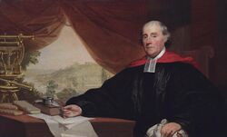 White male with gray hair in academic robes with preaching tabs