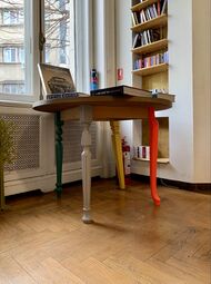 Postmodern table with different legs, some of which are reminiscent of Neoclassical furniture; unknown designer; c.2010; painted wood; unknown dimensions; Cărturești Verona (Strada Arthur Verona no. 15), Bucharest, Romania