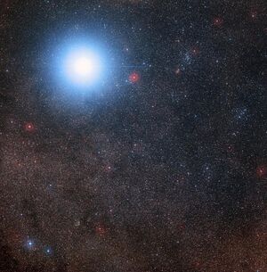One bright star against a dense background of fainter stars, with one of the fainter stars circled and annotated.