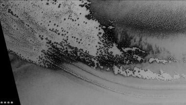 Defrosting going on in Playfair crater, as seen by CTX camera (on Mars Reconnaissance Orbiter). Dark areas are where frost has disappeared thereby showing dark ground. Note: this is an enlargement of the previous image of Playfair crater.