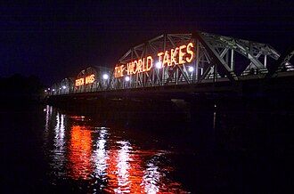 The Lower Trenton Bridge over the Delaware River, by which Amtrak and local trains cross from Trenton into Pennsylvania, is visible to automobile traffic crossing the river on U.S. Route 1. For many years, one of the letters of the sign "Trenton Makes, the World Takes" was burned out and was finally replaced in 2016 immediately before Donald Trump visited the city.