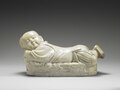 Ding ware pillow in the shape of a recumbent child, Northern Song dynasty (12th century). National Palace Museum, Taipei.