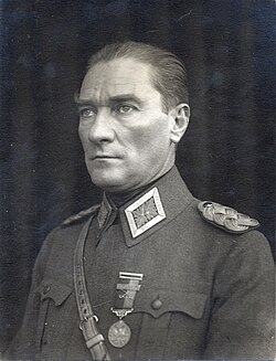 Black-and-white bust-length portrait photo of a clean-shaven middle-aged white man dressed in a military uniform