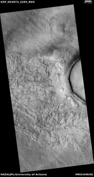 Wide view of fractured surface and pits along wall of crater, as seen by HiRISE under HiWish program