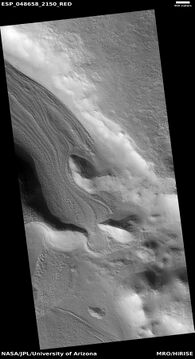 Valley showing Lineated valley fill (LVF), as seen by HiRISE under HiWish program. A linear valley flow is caused by ice movements. The LVF is a glacier covered with debris. That covering protects it from the ice disappearing.