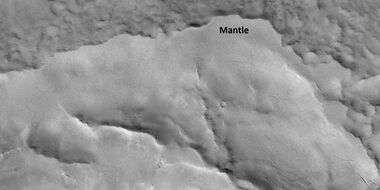 Close view of mantle near a layered feature, as seen by HiRISE under HiWish program Mantle is deposited when the climate changes. It is composed of ice-coated dust.
