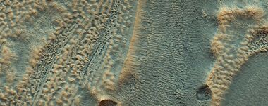 Close, color view of ice layers in crater in previous image, as seen by HiRISE under HiWish program. Both, open and closed brain terrain are visible.