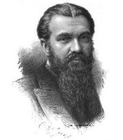 Portrait of a man with dark hair and a long beard
