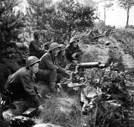 British Vickers gunners in action in the Netherlands during Operation Market Garden. All are wearing the Mk III Turtle helmet.